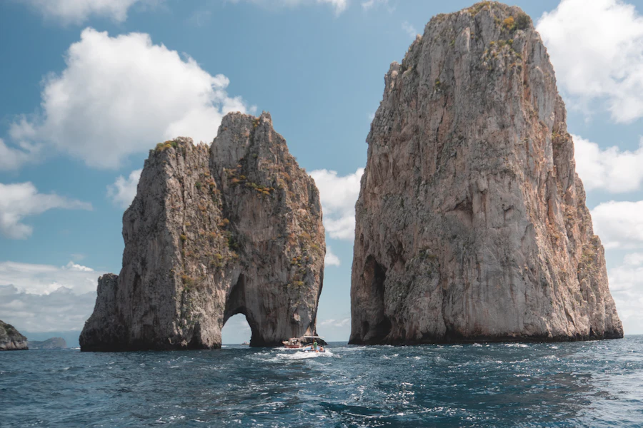 Les Faraglioni et leur arche vus d'un bateau